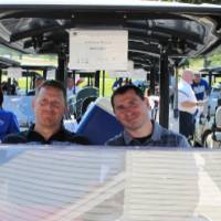 another 2 men in golf cart